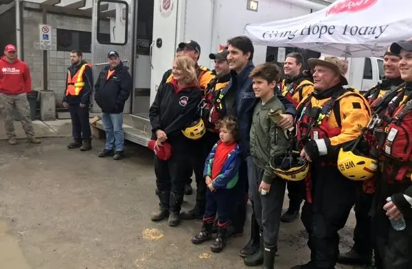 نخست وزیر کانادا و پسرانش در حال کمک به سیل زدگان+ عکس